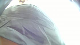 Big ass brunette standing in the city while getting filmed upskirt