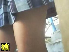 Girl in school uniform climbing up the stairs in this voyeur video