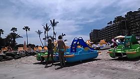 Two candid women topless on beach