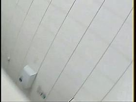 Woman with beautiful butt is pissing on the toilet