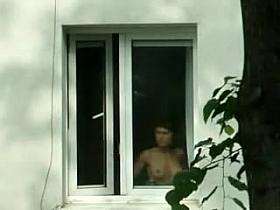 Hot undressed brunette is spied in the window