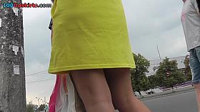 Hot upskirts with slender brunette in yellows dress