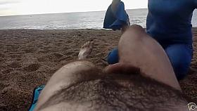 Hairy guy gets a leg massage on the beach