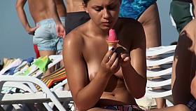 Topless chick eats an ice cream