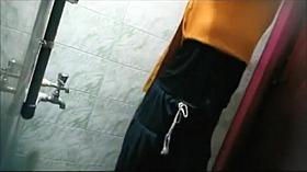 Teen girl prepares water for a shower