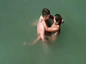 Nudist couple fucks in water