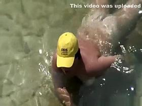 Mature nudist with yellow hat on her head