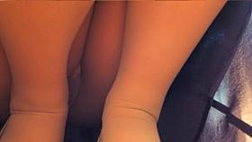 Asian beauty sitting on hunkers and flashing slit up skirt