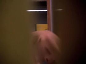 Girl in changing room leans forward and shakes small tits