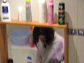 Fem with bushy cunt stays before mirror on spy camera