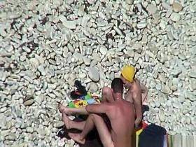 Nudist redhead swimming in the water