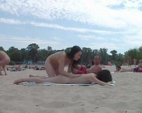 Young nudist friends naked together at the beach