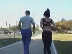 Girl in short top and tight pants running in the street 04i