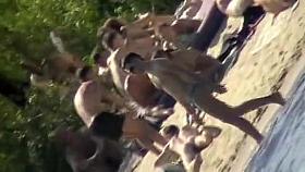 Young nudists take off their clothes to soak up some sun on