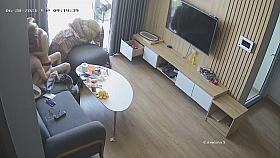 Young couple in livingroom, riding on sofa