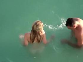 Nudist couple enjoying the fresh water