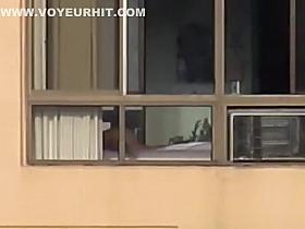Naked mature spied through her apartment window