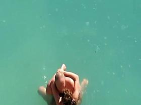 Nude couple fucking in water