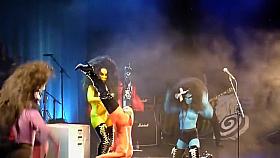 Painted boobs bounce around on the stage at a rock concert