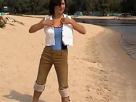 Busty Russian goddess undresses and tans at the beach