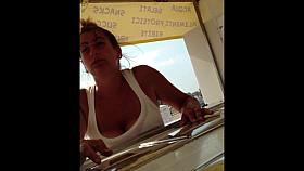 Busty girl selling ice-creams on the beach