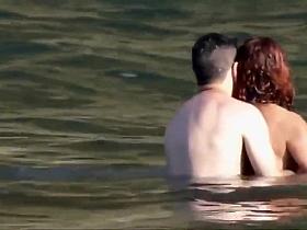 Stones on a naked beach woman