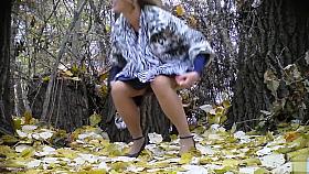 Bride struggles with her wedding dress as she pees in the woods