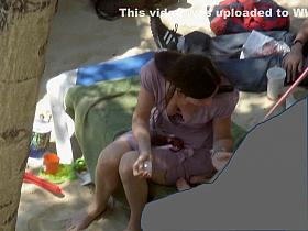 Irresistible gals enjoy sunbathing at a sandy beach