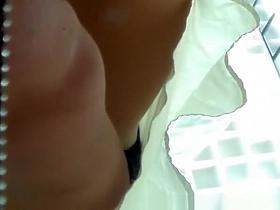Upskirt voyeur films woman's black panties