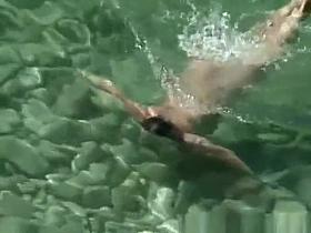 Chubby nudist woman with tattooed arm