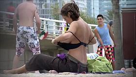 Milf with amazing tits filmed topless at the beach