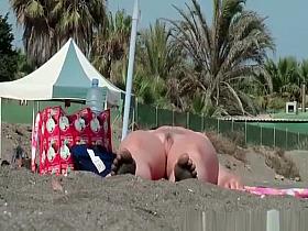 Nudist chicks in water and sunbathing