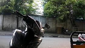 Asian waitress sweeps the street wearing very high heels