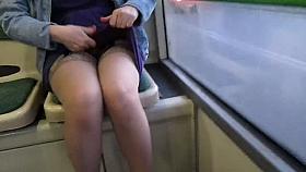 Girl checking stockings and suspenders in a bus