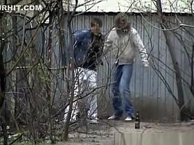 Two friends peeing outdoors