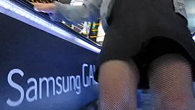 Flashing fishnet stockings tops on escalator