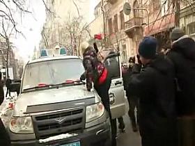 Topless protesters draw a crowd of admirers