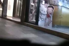 Slender brunette lets a voyeur watches her skirt