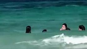 Topless girls running in the water