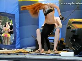 Foxy girl does a lap dance in a studio