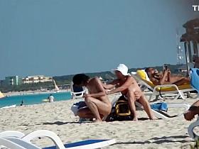 Mature nudist lady puts lotion on herself