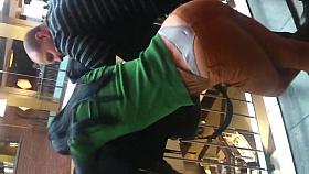 Girl in thong in a shopping mall