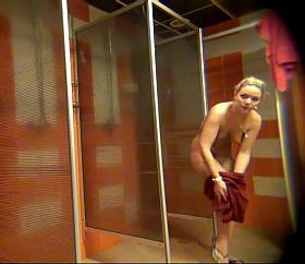 Blonde with a sleek body and shaved cunt takes a shower.