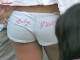 Dark skinned beauty stands in short shorts and a thong ass vid