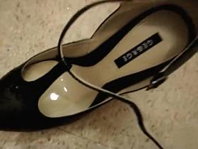 Desperate girl peeing into her shoe in a dressing room