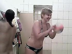 Women talking and dressing in locker room