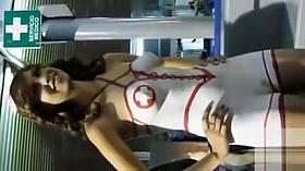 Beautiful model gets a nurse outfit painted on her naked body