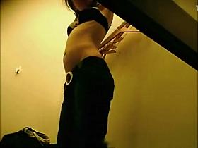 Chick in dressing room trying new clothes