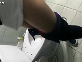 Girl cleans the toilet seat and pees