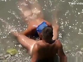 Woman blows her man's cock in the water